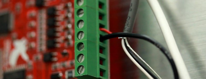 The 24V ground terminal strip is connected to the DCM terminal on the Mach3 USB controller.